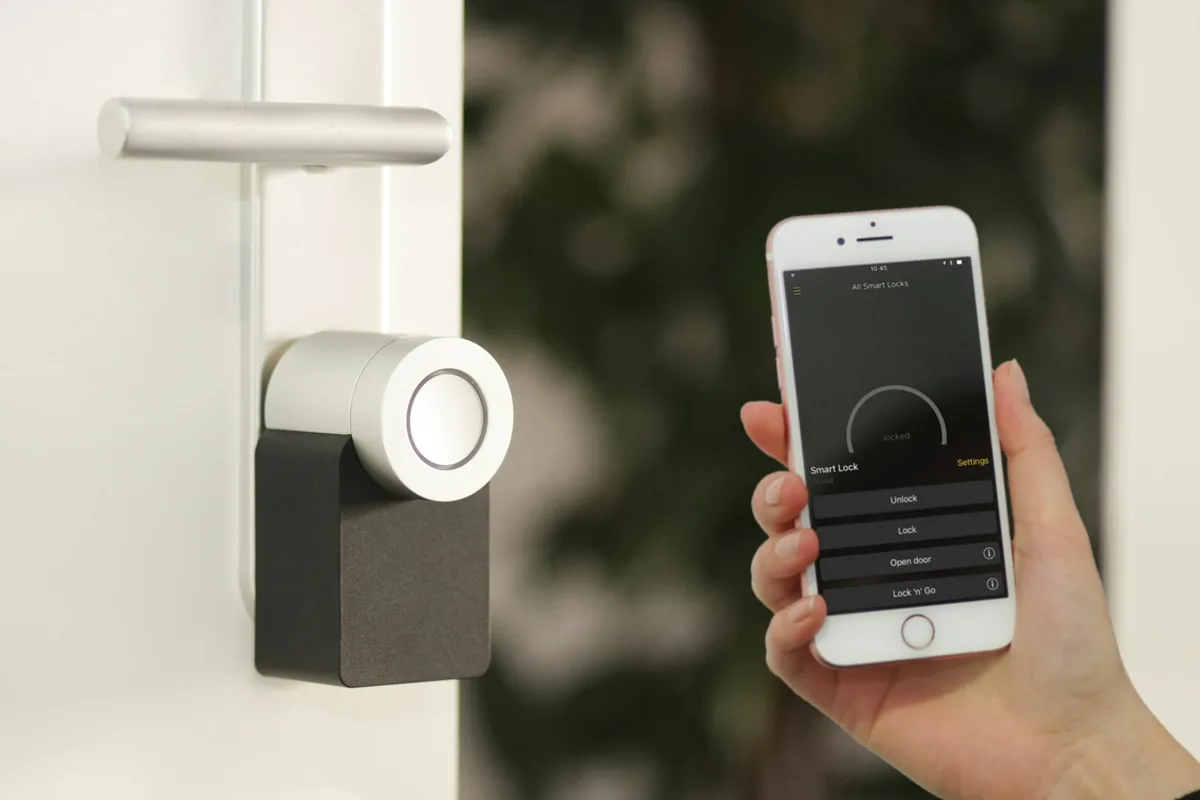 Minimalist smart digital thermostat mounted on an apartment wall for automated home energy savings and comfort